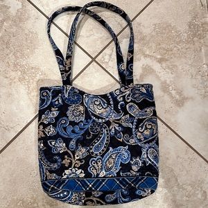 Cute Vera Bradley bag with snap closure and outside zippered pocket.